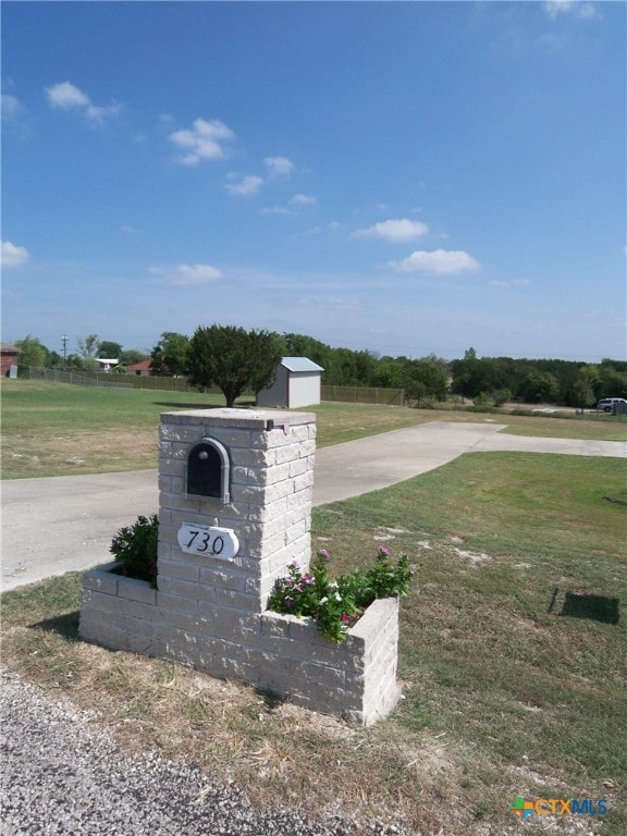 community / neighborhood sign with a lawn