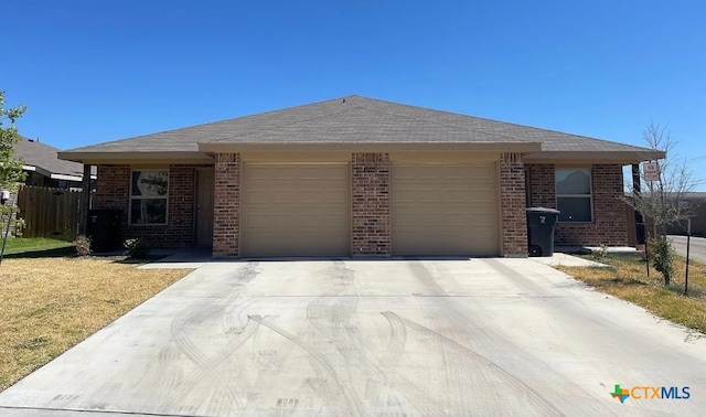 ranch-style house featuring a garage and a front lawn