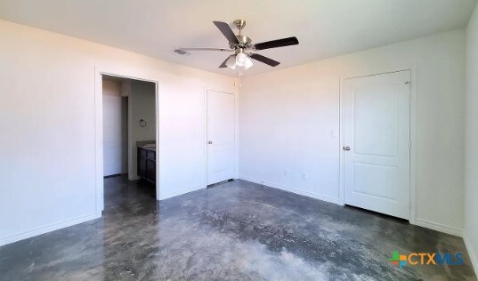 unfurnished bedroom with ceiling fan and ensuite bath