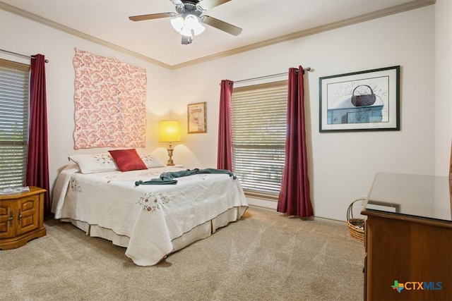 carpeted bedroom with ceiling fan, multiple windows, and ornamental molding