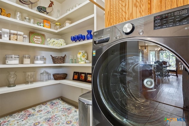 laundry area with hardwood / wood-style floors and washer / dryer