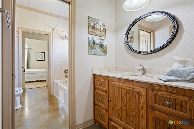 bathroom featuring ornamental molding, vanity, and toilet