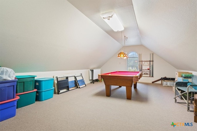 game room featuring a textured ceiling, pool table, vaulted ceiling, and carpet