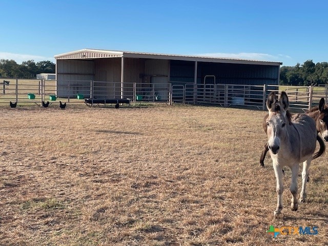 view of stable with a rural view