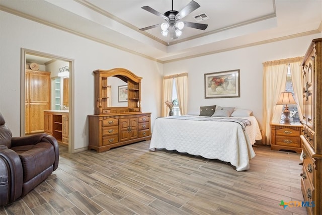 bedroom with ornamental molding, hardwood / wood-style floors, ceiling fan, and ensuite bathroom