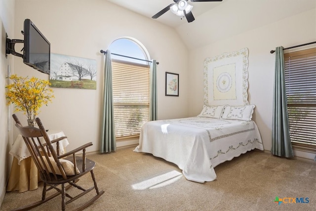 bedroom with light colored carpet, multiple windows, lofted ceiling, and ceiling fan