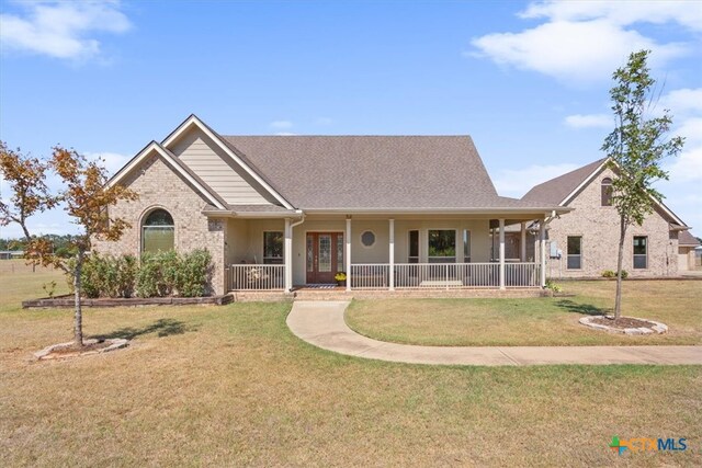 view of front of property with a porch and a front yard