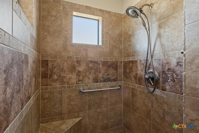 bathroom with tiled shower