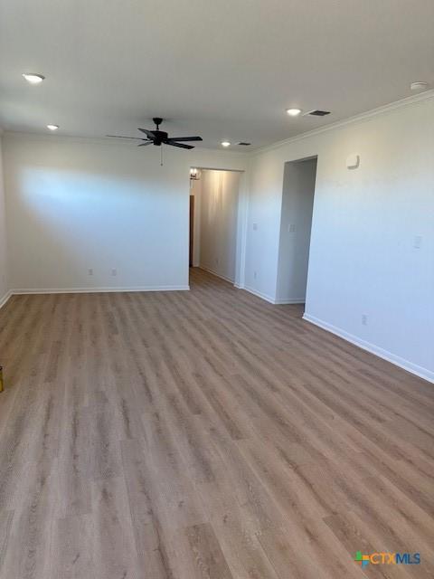 unfurnished room featuring recessed lighting, wood finished floors, a ceiling fan, baseboards, and ornamental molding