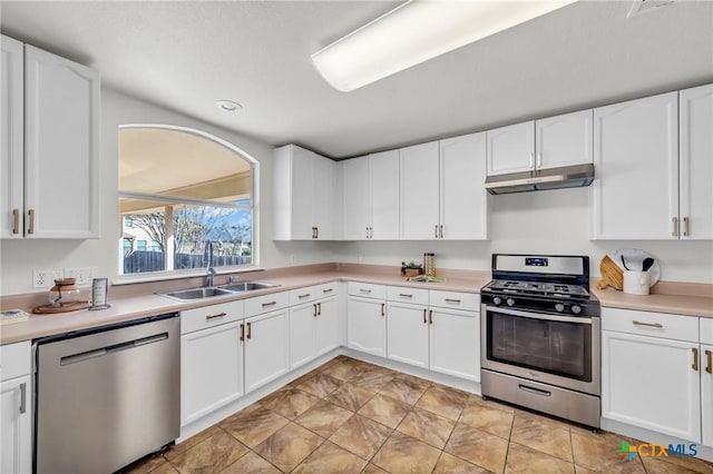 7016 Albacete Ln, Round Rock, TX 78681 - kitchen with stainless steel appliances, under cabinet range hood, light countertops, white cabinets, and recessed lighting