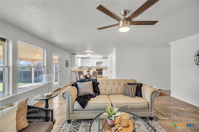 7016 Albacete Ln, Round Rock, TX 78681 - living area featuring light tile patterned floors, a ceiling fan, and a textured ceiling