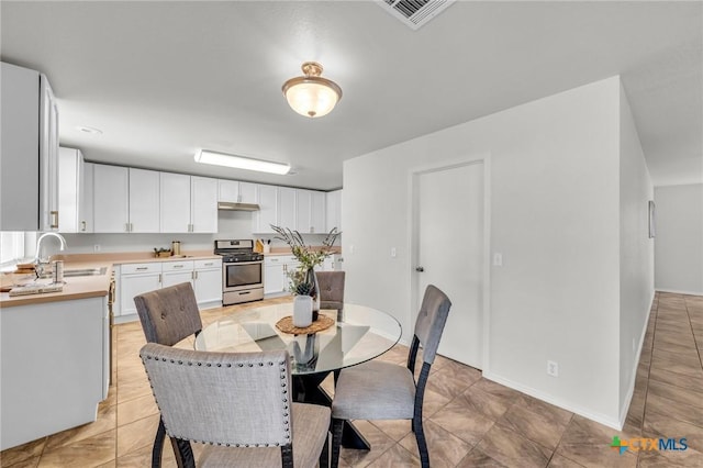 7016 Albacete Ln, Round Rock, TX 78681 - dining room with light tile patterned floors and baseboards