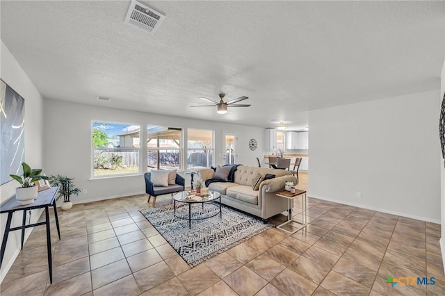 7016 Albacete Ln, Round Rock, TX 78681 - living room with ceiling fan, a textured ceiling, and tile patterned flooring