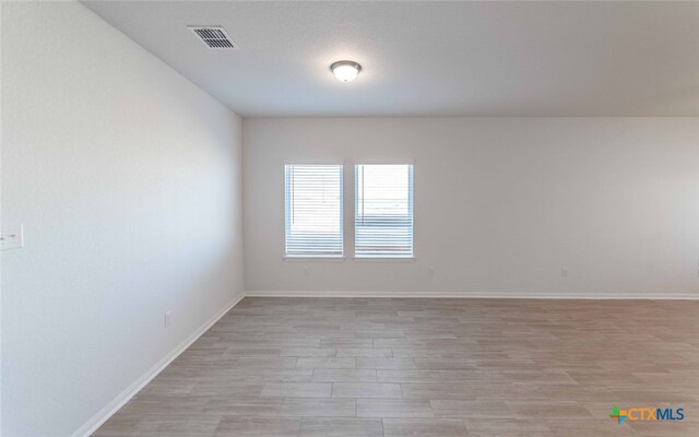 spare room featuring light wood-type flooring