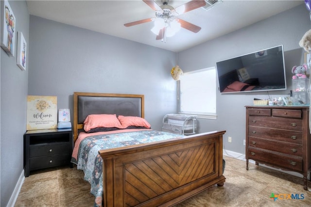 bedroom featuring ceiling fan, visible vents, and baseboards