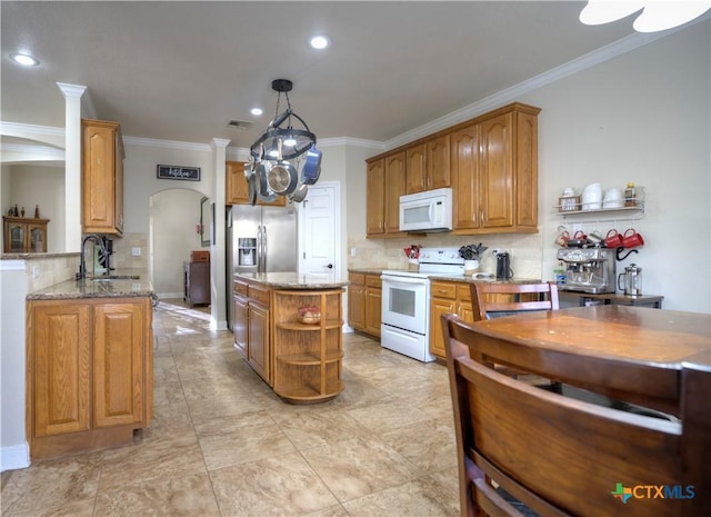 kitchen with white appliances, arched walkways, light stone counters, open shelves, and a sink