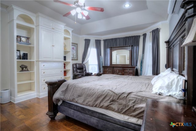 bedroom featuring a tray ceiling, dark wood finished floors, recessed lighting, ornamental molding, and a ceiling fan