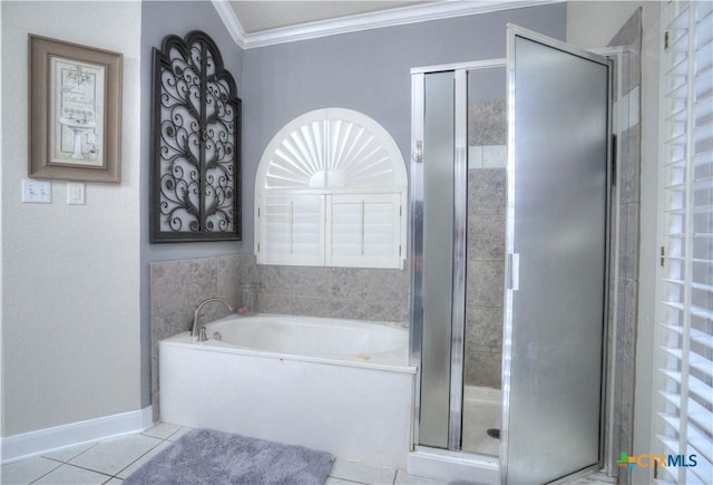 bathroom with a stall shower, baseboards, ornamental molding, tile patterned floors, and a garden tub