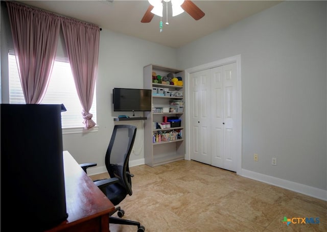 office area featuring ceiling fan and baseboards