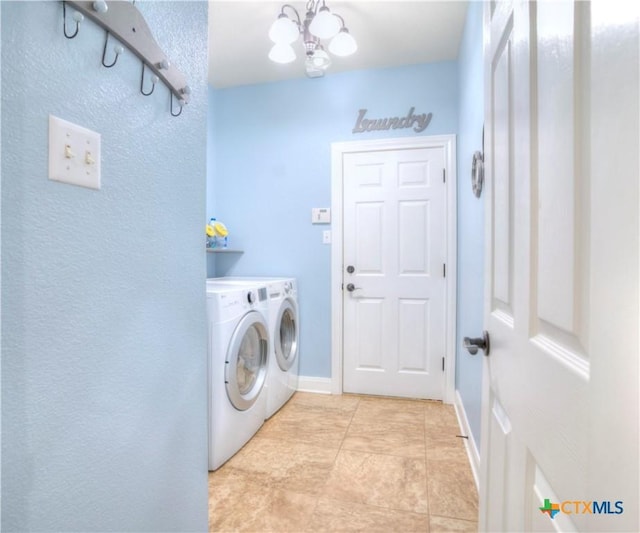 washroom with light tile patterned floors, an inviting chandelier, washer and dryer, laundry area, and baseboards