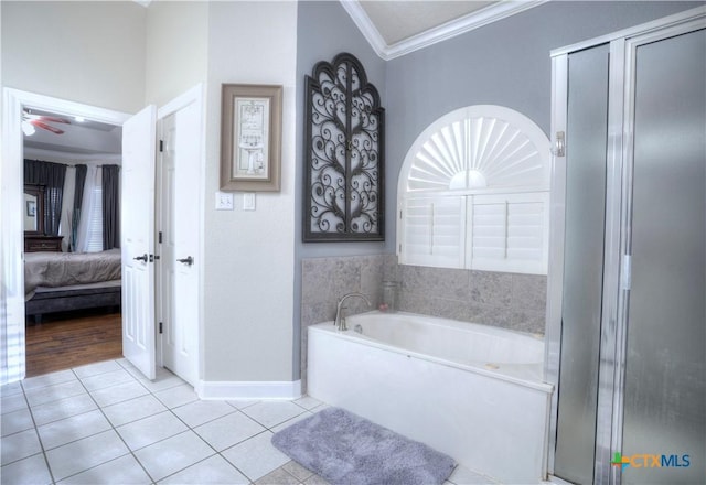 bathroom with ensuite bathroom, tile patterned flooring, baseboards, ornamental molding, and a bath