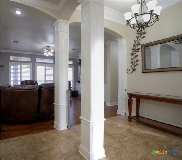 interior space featuring arched walkways, a ceiling fan, visible vents, decorative columns, and crown molding