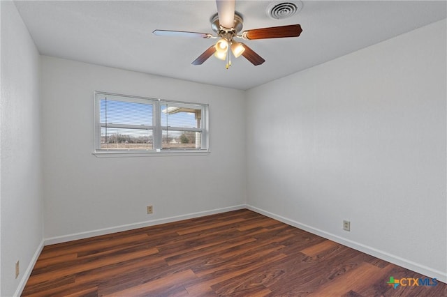 spare room with ceiling fan and dark hardwood / wood-style floors