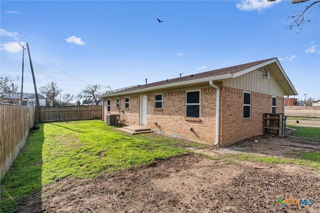 back of property with a yard and cooling unit