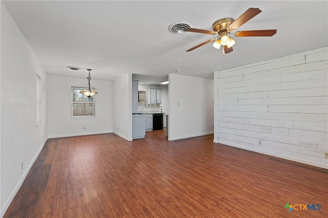 unfurnished living room featuring dark hardwood / wood-style floors and ceiling fan