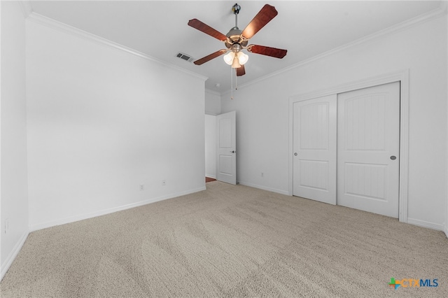 unfurnished bedroom featuring ceiling fan, carpet floors, and ornamental molding