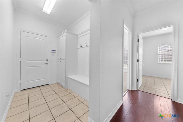 mudroom with ornamental molding and light hardwood / wood-style flooring