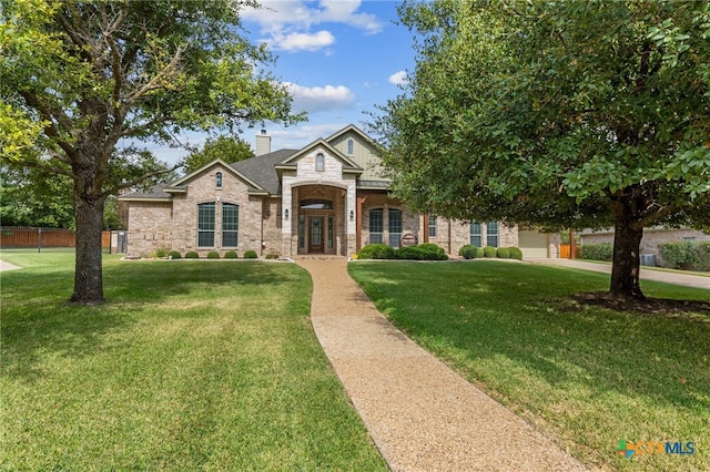 view of front of property featuring a garage and a front yard