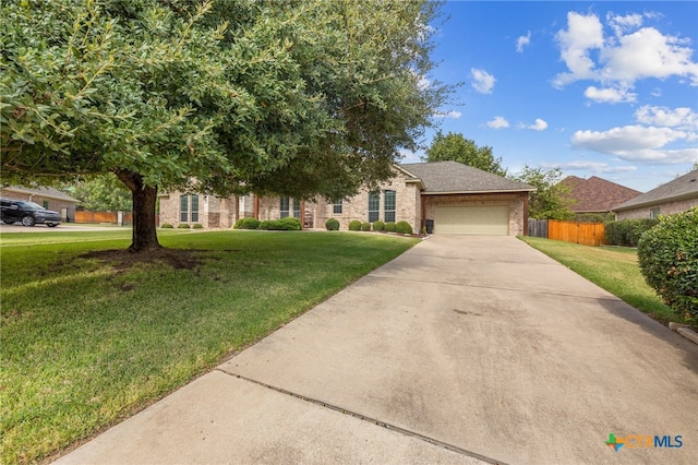 view of front of property featuring a front yard and a garage