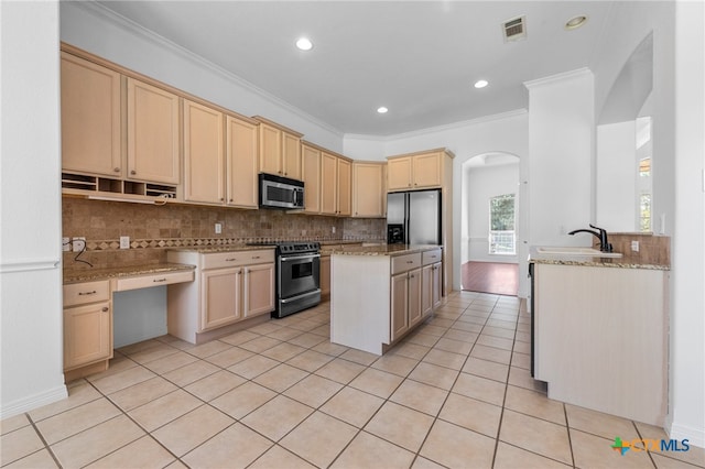 kitchen featuring ornamental molding, appliances with stainless steel finishes, light stone countertops, decorative backsplash, and sink