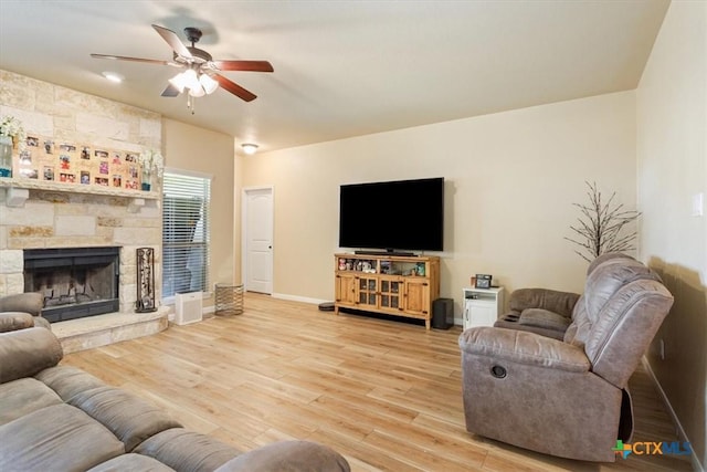3425 Doss St, Copperas Cove, TX 76522 - living room featuring a ceiling fan, wood finished floors, and a fireplace