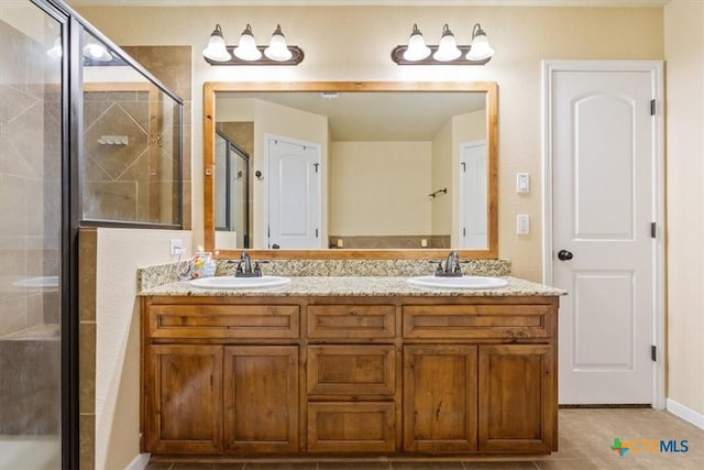 3425 Doss St, Copperas Cove, TX 76522 - bathroom featuring a shower stall, double vanity, and tile patterned floors