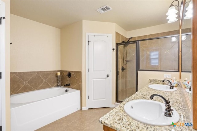 3425 Doss St, Copperas Cove, TX 76522 - full bathroom with tile patterned floors, double vanity, a bath, and a shower stall