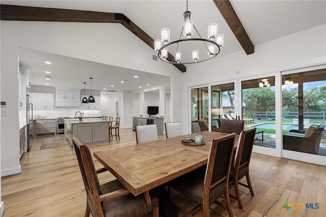 dining area with light wood-type flooring, high vaulted ceiling, sink, beamed ceiling, and a chandelier