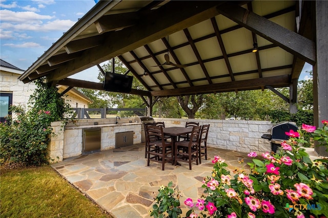 view of patio with an outdoor kitchen, a grill, and a gazebo