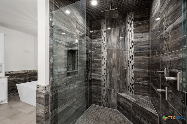 bathroom featuring tile walls, vanity, tile patterned floors, and independent shower and bath