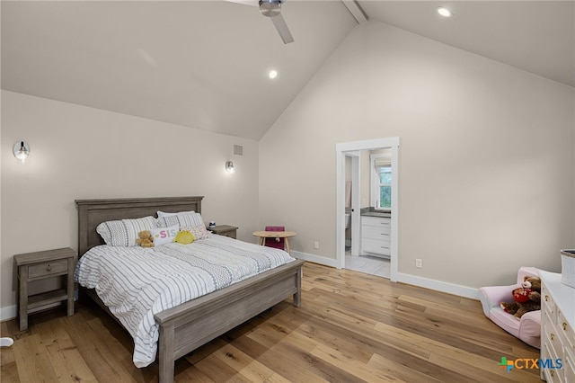 bedroom with high vaulted ceiling, light hardwood / wood-style flooring, ceiling fan, and ensuite bath