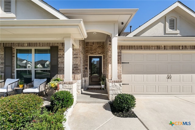 2233 Sauterne Dr, Leander, TX 78641 - property entrance with a porch, a garage, stone siding, brick siding, and driveway