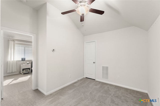 2233 Sauterne Dr, Leander, TX 78641 - unfurnished bedroom featuring vaulted ceiling, light carpet, baseboards, and ceiling fan