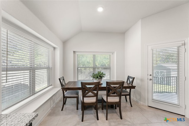 2233 Sauterne Dr, Leander, TX 78641 - dining space featuring light tile patterned floors, vaulted ceiling, and baseboards