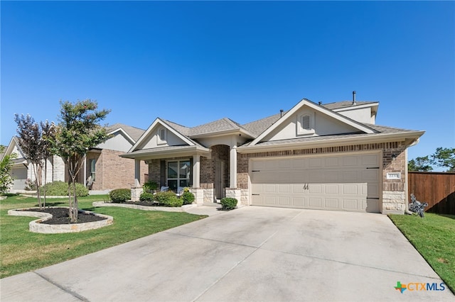 2233 Sauterne Dr, Leander, TX 78641 - view of front of home with concrete driveway, an attached garage, brick siding, roof with shingles, and stucco siding