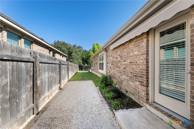 2233 Sauterne Dr, Leander, TX 78641 - view of home's exterior featuring brick siding, a fenced backyard, and a patio area