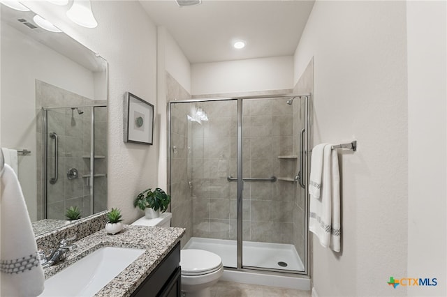 2233 Sauterne Dr, Leander, TX 78641 - bathroom featuring a stall shower, vanity, tile patterned floors, and toilet