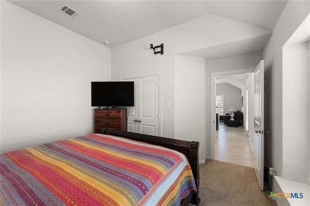 2233 Sauterne Dr, Leander, TX 78641 - bedroom with vaulted ceiling, light carpet, and light tile patterned flooring