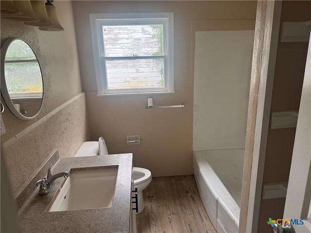1315 S 51st St, Temple, TX 76504 - bathroom with toilet, wood finished floors, and vanity