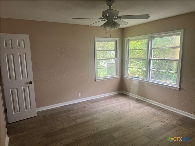1315 S 51st St, Temple, TX 76504 - unfurnished room featuring wood finished floors, a textured wall, baseboards, and a ceiling fan
